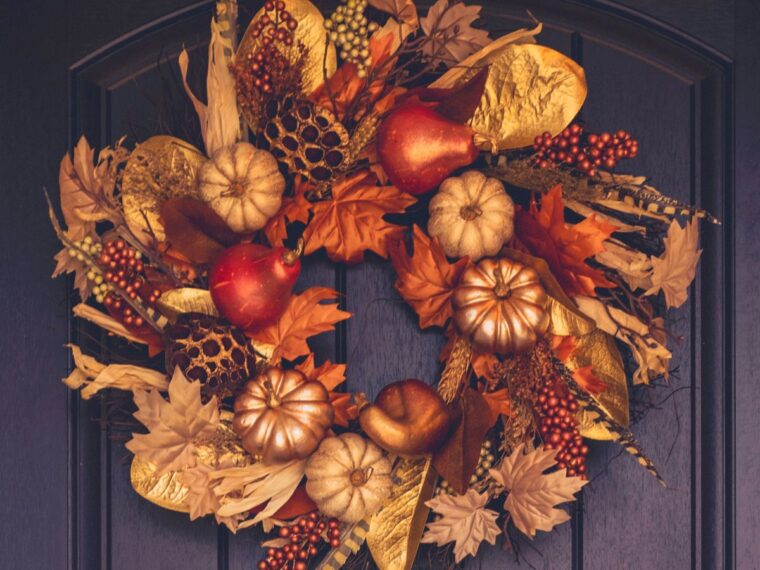 A fall wreath on a black front door